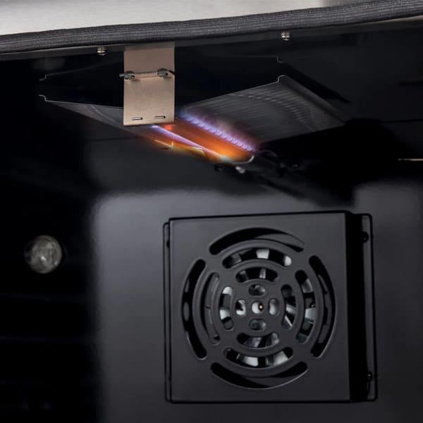Interior view of the FORNO 36-inch gas range in stainless steel with the oven turned on, showing the illuminated cavity and glowing burner for active cooking.