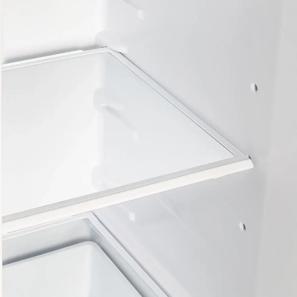 Close-up view of an interior shelf inside the Forno 36-inch side-by-side refrigerator in white, featuring a clear, adjustable glass surface designed for flexible and organized food storage.