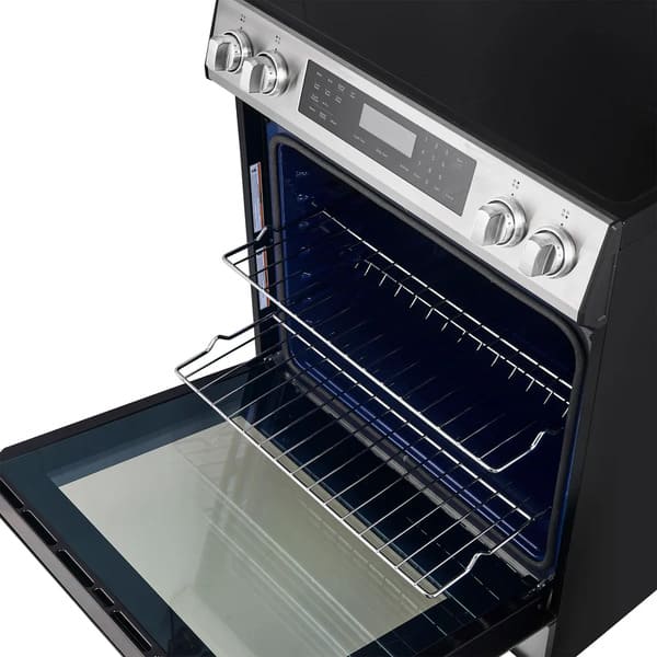 Interior view of the FORNO 30-inch induction range in stainless steel, showcasing multiple adjustable oven racks and spacious cooking capacity.