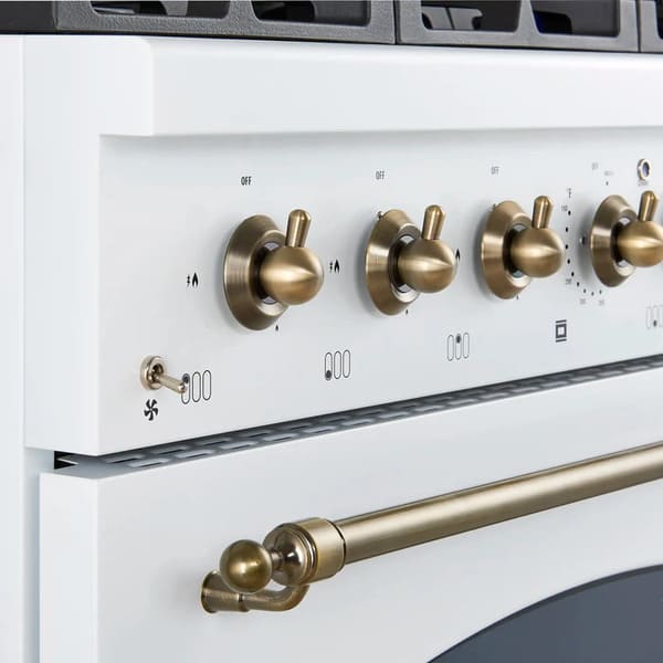 Close-up of the stainless steel control knobs on the FORNO Antico 36-Inch Gas Range in white, featuring polished brass bezels and precision temperature markings for professional-grade cooking control.