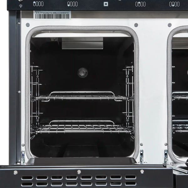 Interior view of the secondary oven in the FORNO Antico 48-Inch Dual Fuel Range in black, showcasing a compact blue enamel cavity with convection fan and adjustable oven rack.