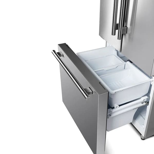 Left-angled view of the FORNO 30-inch French door refrigerator in stainless steel with the bottom freezer drawer open, showing the roomy interior and organized freezer compartments.