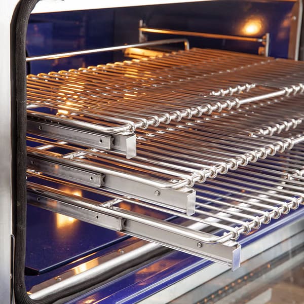 Open oven view of FORNO Capriasca 36" Gas Range featuring spacious blue enamel interior, convection fan, and 3 heavy-duty sliding racks.

