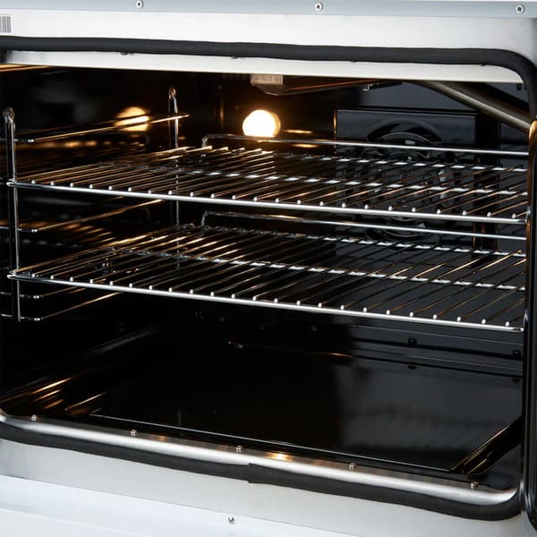 Close-up of the oven interior in the FORNO Galiano 30-Inch French Door Dual Fuel Range in white, highlighting the stainless steel telescopic oven racks and blue enamel cavity.