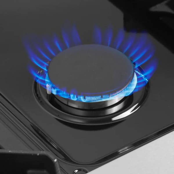 Close-up of a gas burner on the FORNO Galiano 36-Inch French Door Dual Fuel Range in White, highlighting the durable cast-iron grate and precision flame control.