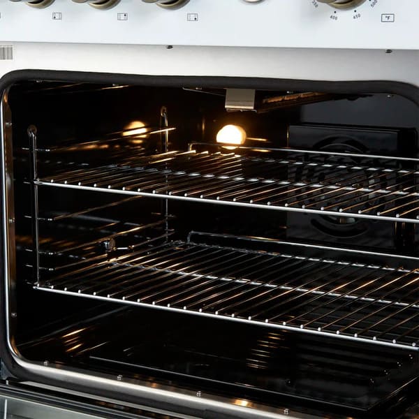 Right-angled interior view of the FORNO Marco 30-Inch Gas Range in white, featuring a blue enamel oven interior, convection fan, and adjustable chrome racks for multi-level cooking versatility.
