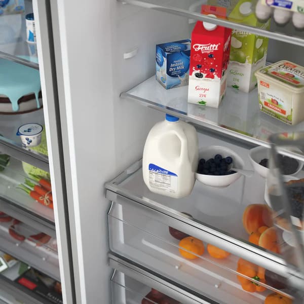 Close-up of lower drawer on FORNO Maderno 60-Inch Convertible Refrigerator-Freezer, showcasing smooth glide tracks, stainless steel finish, and deep storage capacity.