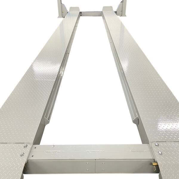 Close-up of Triumph NTR-32 four post lift showing diamond plate steel runways for durability.