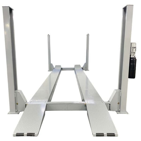 Front view of Triumph NTR-32 heavy duty four post auto lift with long diamond plate ramps for trucks and buses.