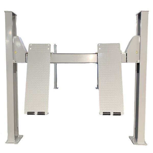 Rear view of Triumph NTR-32 four post auto lift with dual drive-on ramps extended for easy access.